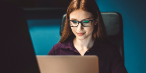 Woman smiling at her computer